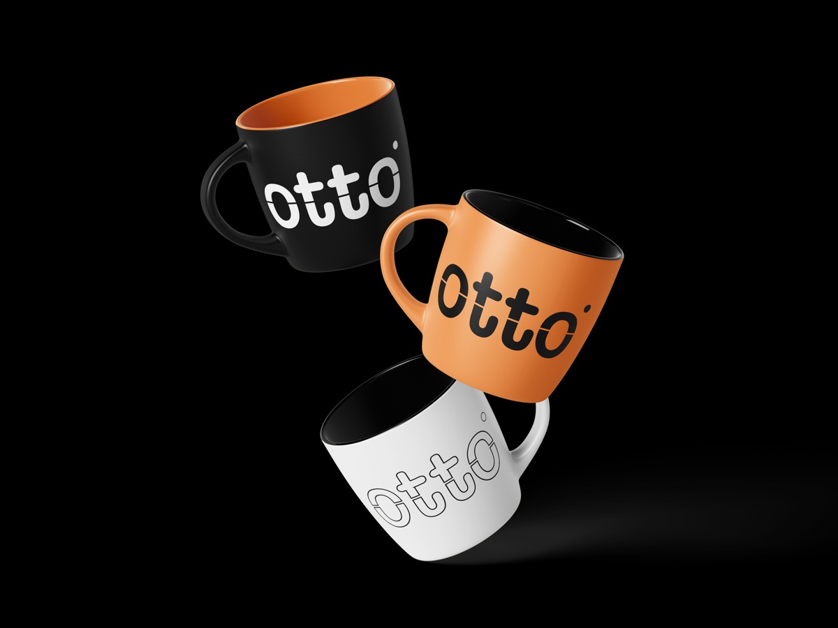 Otto Studio branded mugs in black, orange, and white